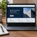 Laptop and phone displaying matching business website layouts beside a planning notebook.